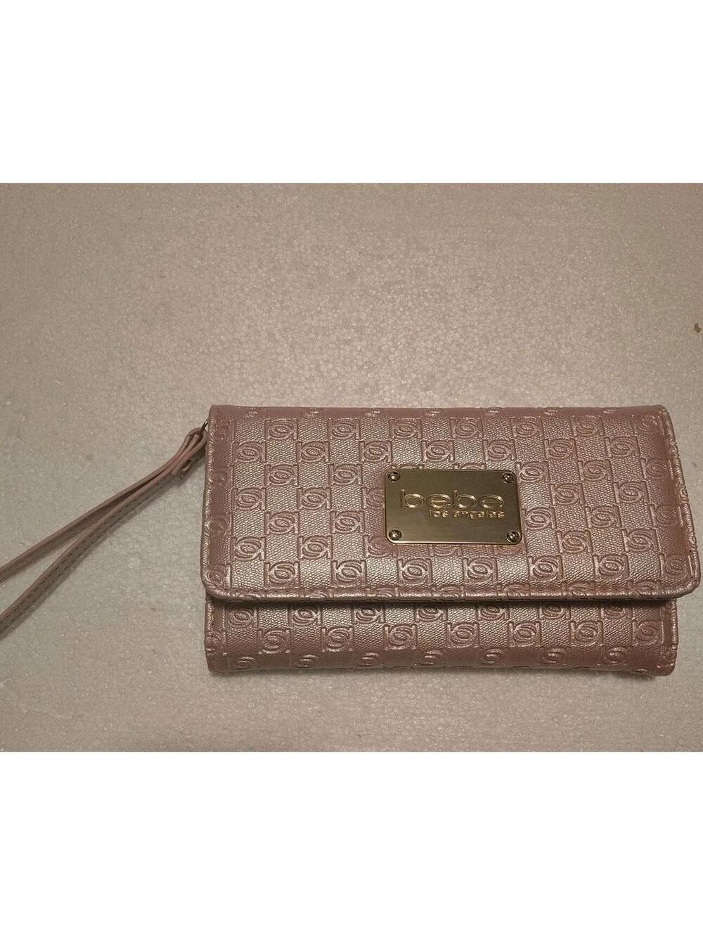 Bebe pale pink monogrammed wallet with a wristlet strap